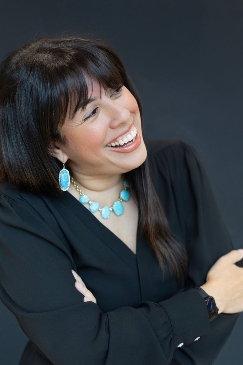 Holly Subervi laughing with her arms crossed