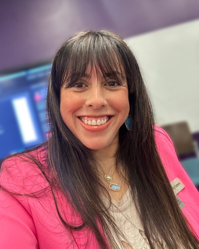Holly Subervi smiling in a pink blazer