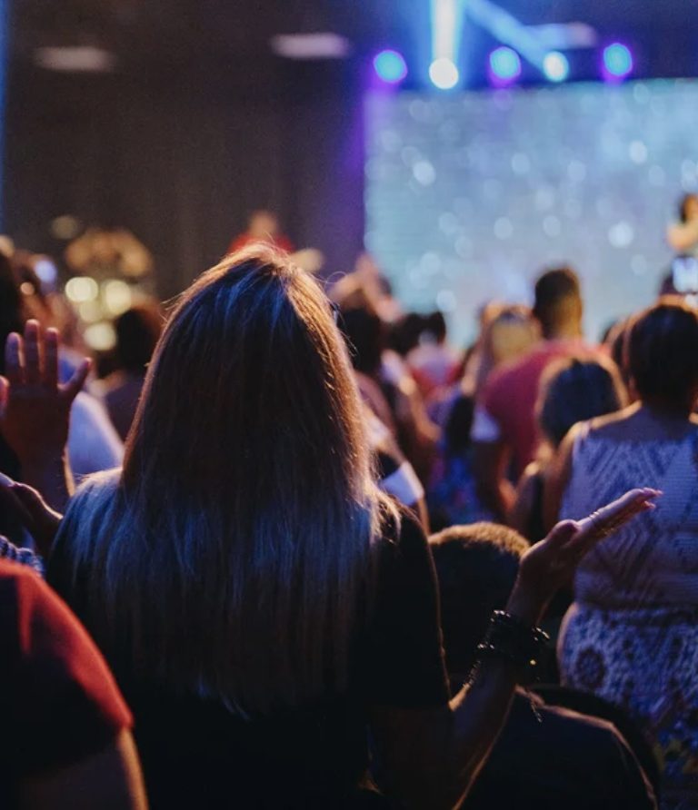 An audience watching a live keynote on stage
